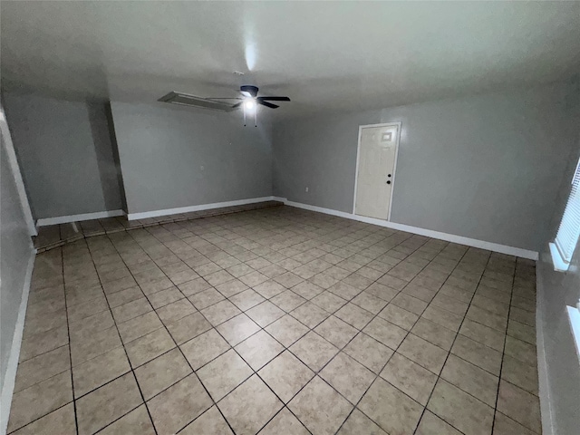 empty room featuring light tile patterned flooring and ceiling fan