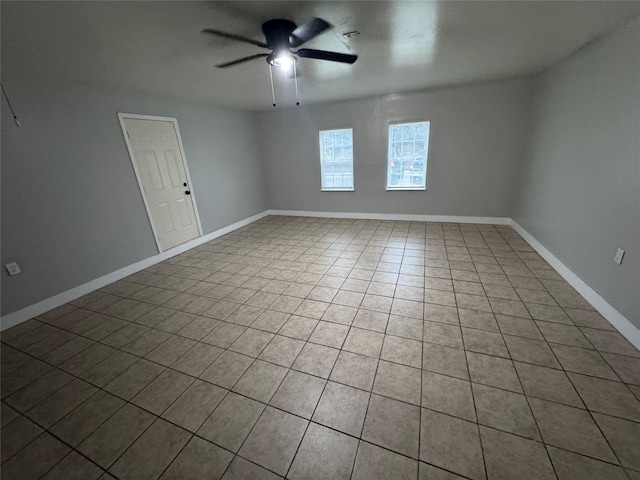 unfurnished room with ceiling fan and tile patterned flooring