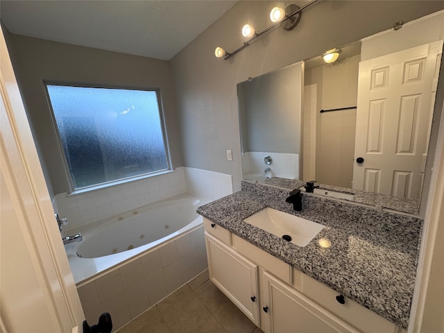 bathroom with vanity, a relaxing tiled tub, and tile patterned floors