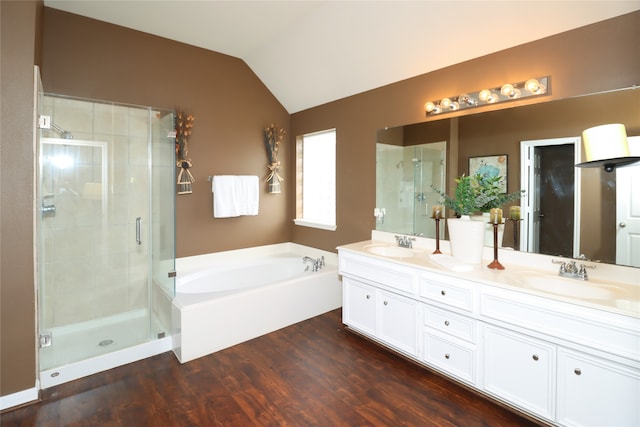 bathroom with independent shower and bath, wood-type flooring, vanity, and lofted ceiling