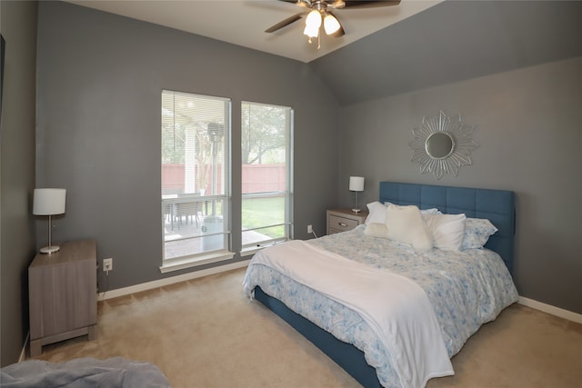 carpeted bedroom with ceiling fan and vaulted ceiling