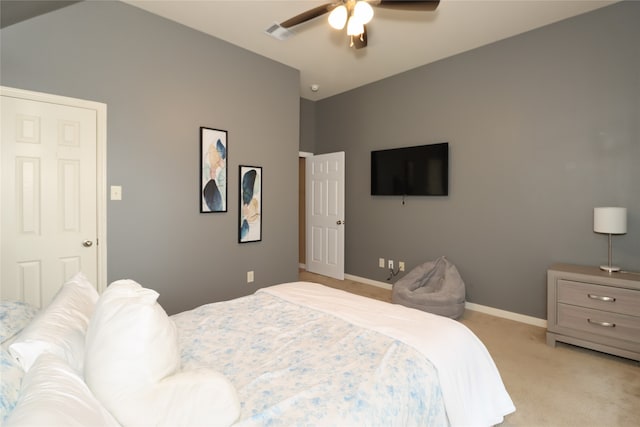 bedroom featuring ceiling fan, lofted ceiling, and light colored carpet