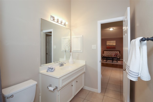 bathroom featuring toilet, vanity, and tile patterned floors