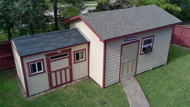 view of outbuilding featuring a lawn