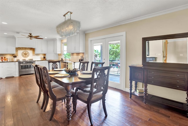 dining room featuring dark hardwood / wood-style floors, ornamental molding, and a textured ceiling