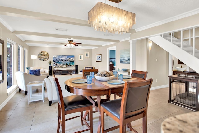 tiled dining area featuring beamed ceiling, ceiling fan with notable chandelier, ornamental molding, and decorative columns