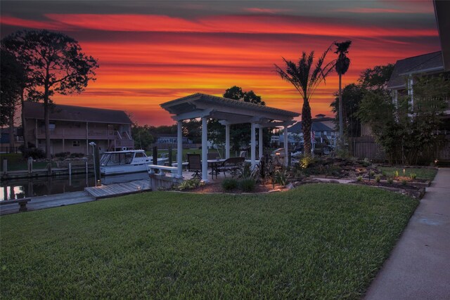 yard at dusk with a boat dock and a pergola