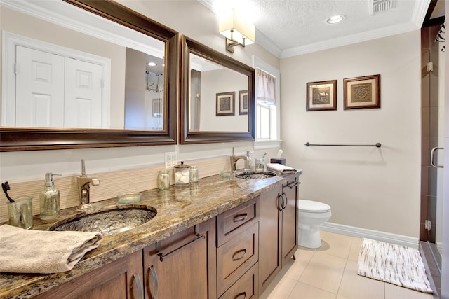 bathroom featuring toilet, vanity, a textured ceiling, and ornamental molding