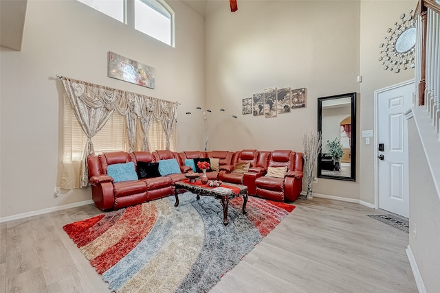 living room featuring hardwood / wood-style floors and a towering ceiling