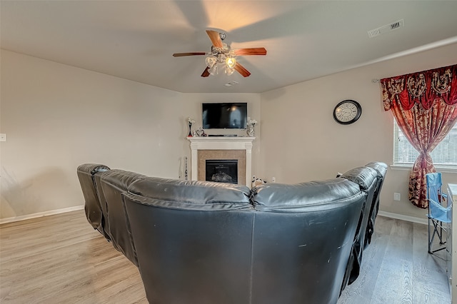 living room featuring light wood-type flooring and ceiling fan