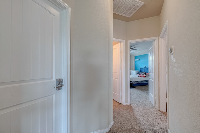 hallway with light colored carpet