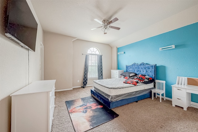 bedroom with a textured ceiling, carpet flooring, and ceiling fan