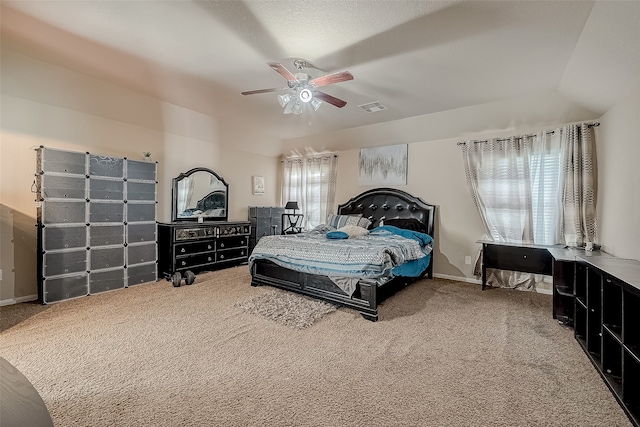 carpeted bedroom featuring multiple windows, ceiling fan, and vaulted ceiling