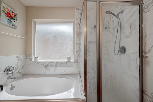 bathroom featuring separate shower and tub