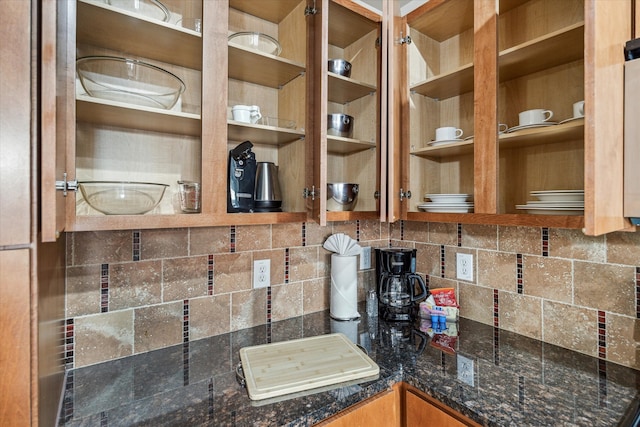 interior details featuring dark stone countertops and tasteful backsplash