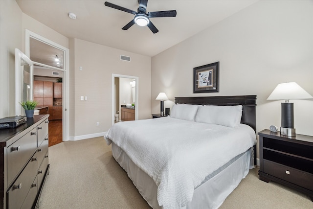 carpeted bedroom featuring ensuite bathroom and ceiling fan