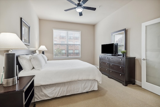 bedroom featuring ceiling fan and light carpet