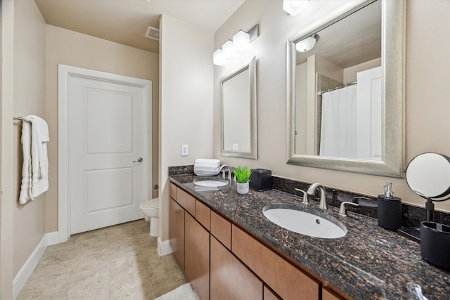 bathroom featuring toilet and vanity