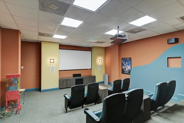 home theater room with a drop ceiling and carpet floors