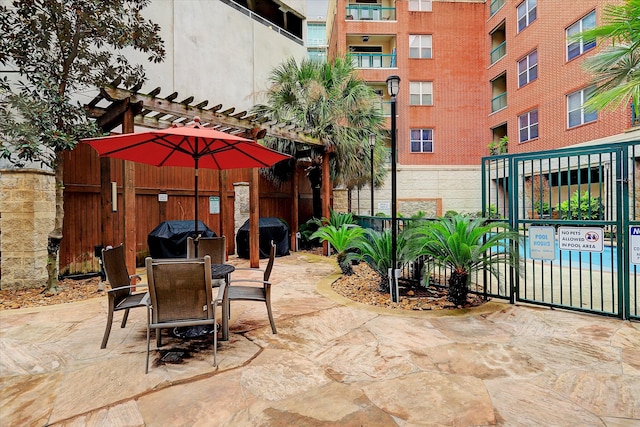 view of patio / terrace with grilling area and a balcony