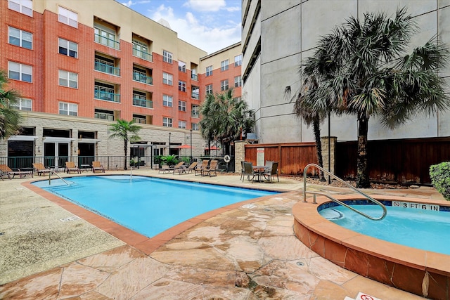 view of pool with a patio area and a hot tub