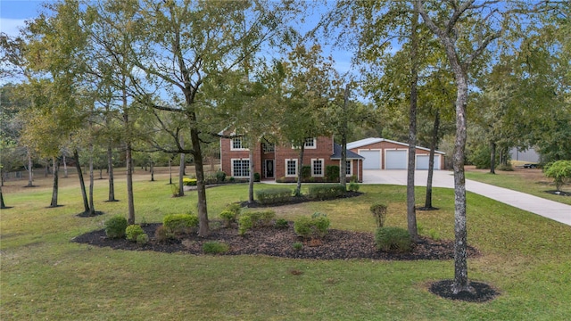 view of front of property with a front yard and a garage