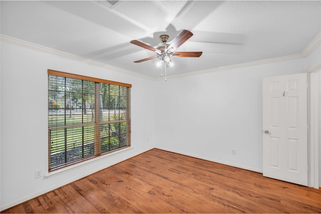 unfurnished room featuring hardwood / wood-style floors, crown molding, and ceiling fan