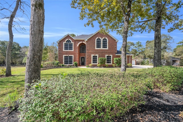 view of front of house with a front yard and a garage