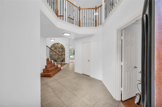 tiled entrance foyer featuring a high ceiling