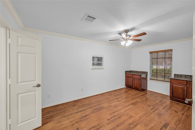 spare room with ornamental molding, hardwood / wood-style flooring, a textured ceiling, and ceiling fan