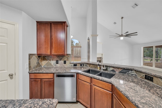 kitchen featuring sink, dishwasher, ceiling fan, and dark stone counters