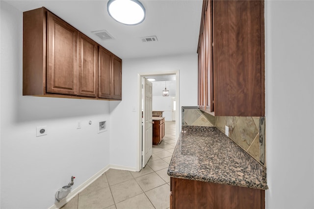 laundry room featuring washer hookup, electric dryer hookup, hookup for a gas dryer, and cabinets