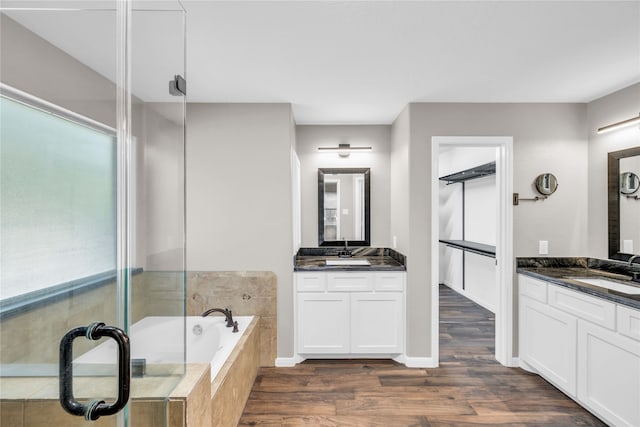 bathroom with vanity, hardwood / wood-style flooring, and shower with separate bathtub