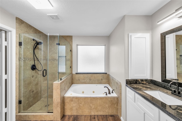 bathroom featuring vanity, a textured ceiling, independent shower and bath, and wood-type flooring