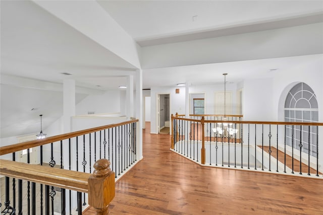 hall featuring a notable chandelier and hardwood / wood-style floors