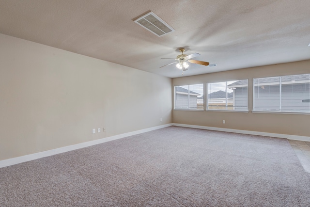 unfurnished room with a textured ceiling, ceiling fan, and carpet floors