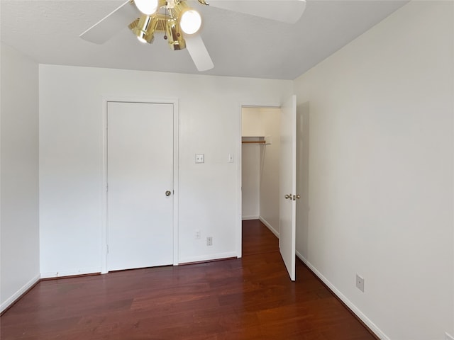 unfurnished bedroom featuring dark wood-type flooring and ceiling fan