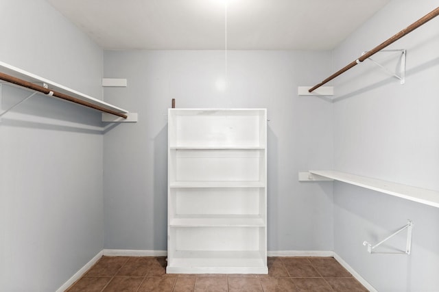 walk in closet with tile patterned flooring