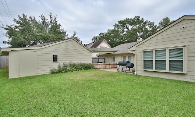 view of yard featuring a storage unit and a patio