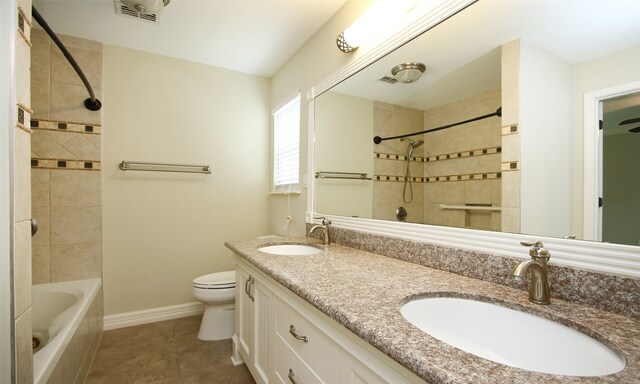 full bathroom with vanity, tile patterned floors, toilet, and tiled shower / bath