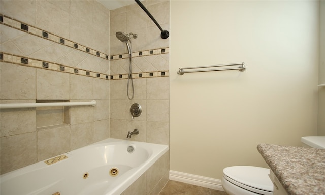 full bathroom with tile patterned floors, vanity, tiled shower / bath combo, and toilet