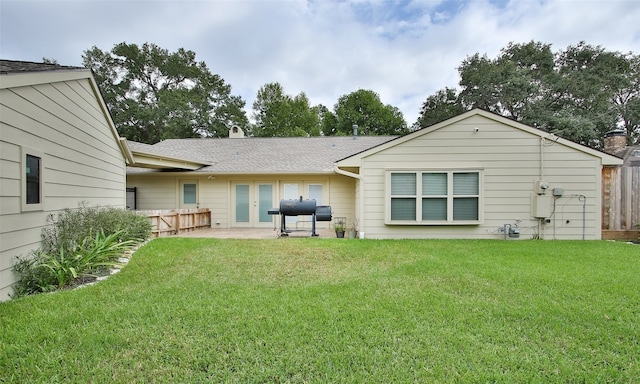 back of property with a patio and a yard