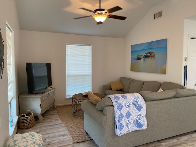 4034 Panola Dr, Galveston, TX 77554 - living room featuring light wood-style floors, lofted ceiling, a ceiling fan, and baseboards