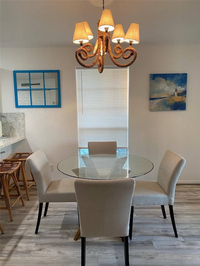 4034 Panola Dr, Galveston, TX 77554 - dining room featuring wood finished floors, a chandelier, and baseboards
