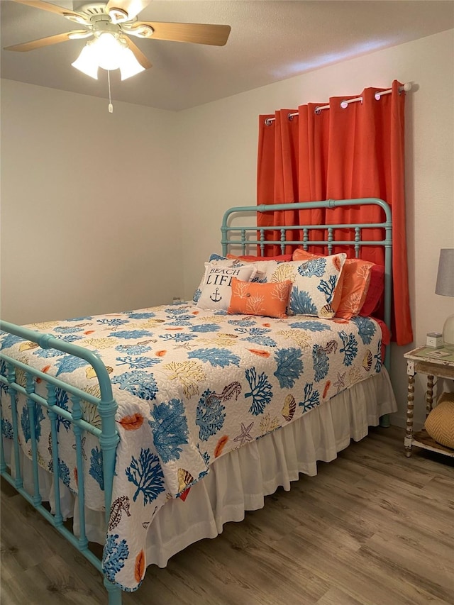 4034 Panola Dr, Galveston, TX 77554 - bedroom with wood finished floors and ceiling fan