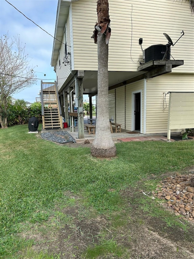 4034 Panola Dr, Galveston, TX 77554 - back of house with stairs, a lawn, a patio area, and a wooden deck