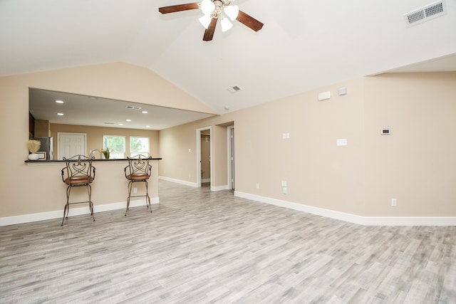 unfurnished living room with light hardwood / wood-style flooring, lofted ceiling, and ceiling fan