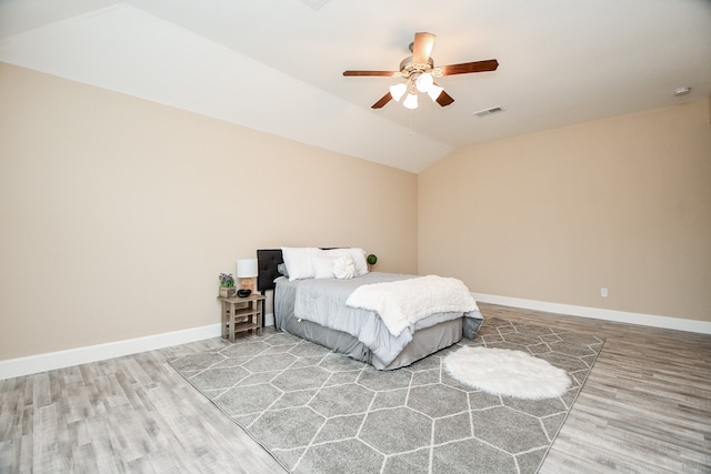 bedroom featuring ceiling fan, wood-type flooring, and lofted ceiling