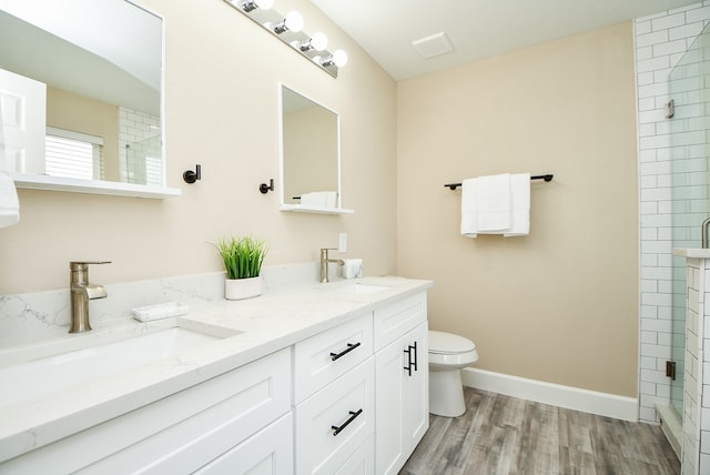 bathroom featuring vanity, hardwood / wood-style flooring, toilet, and an enclosed shower