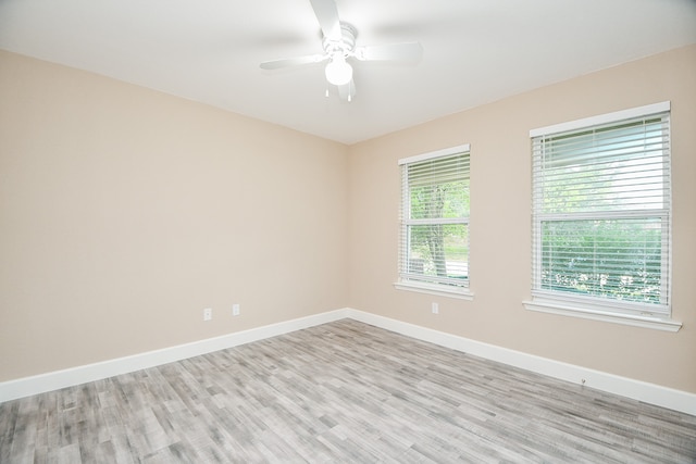 spare room featuring light hardwood / wood-style flooring and ceiling fan